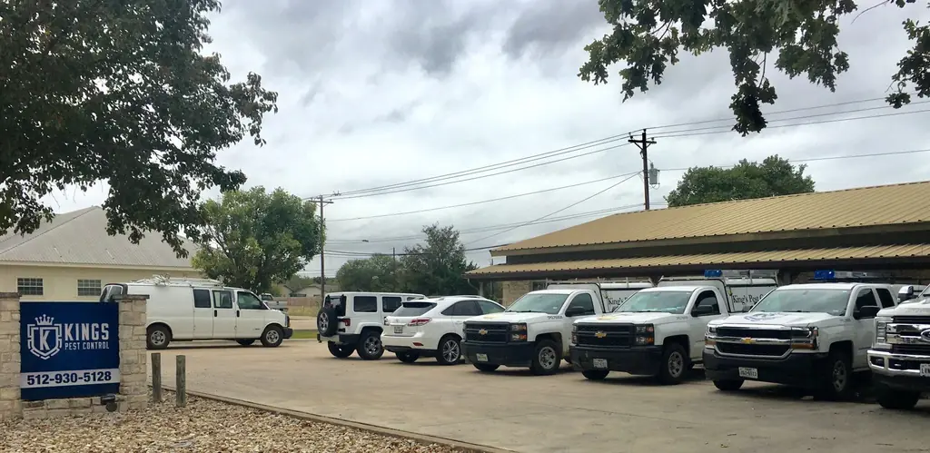 The King's Pest Control monument sign and service truck fleet outside the Georgetown office